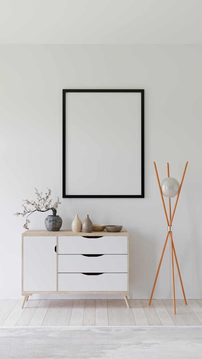 Elegant minimalist interior with empty frame, credenza, and modern decor.